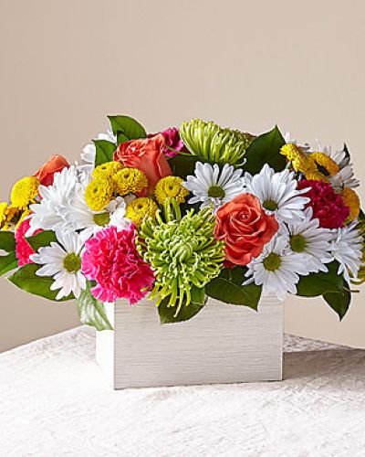 What's the scoop on this bright arrangement Well, our Sorbet Bouquet is curated with a full serving of freshness and fragrance by our local florists to make anyone's day sweeter. This design features roses, spider mums, carnations and poms in a whitewashed wooden box.